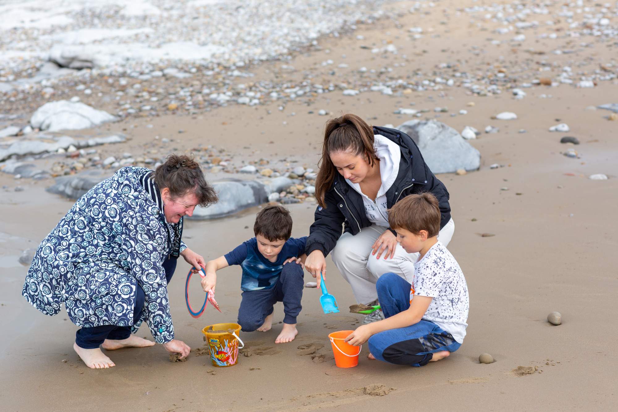 Family playing in the sand on the beach