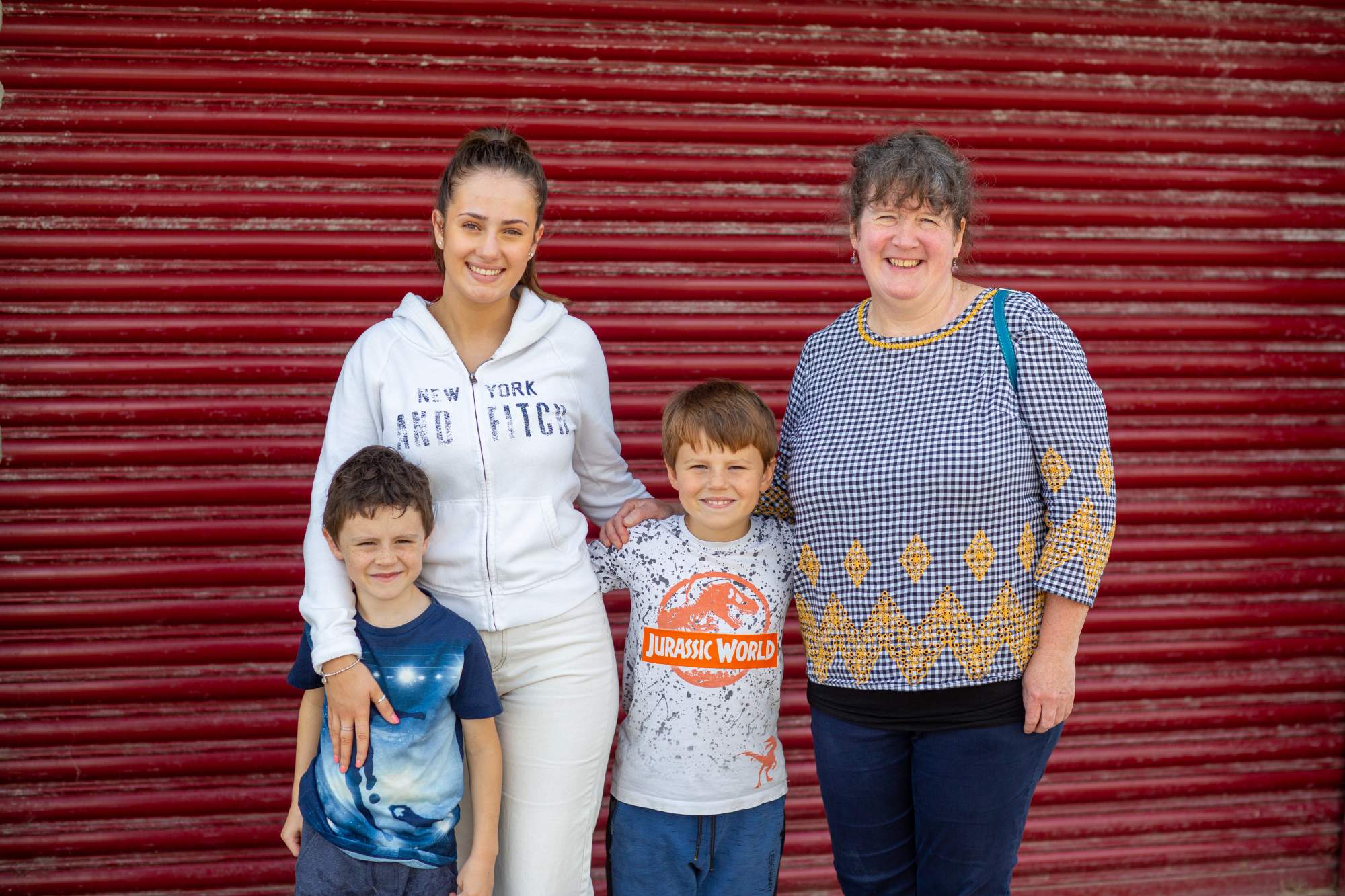 Mum and three children smiling and posing for photo