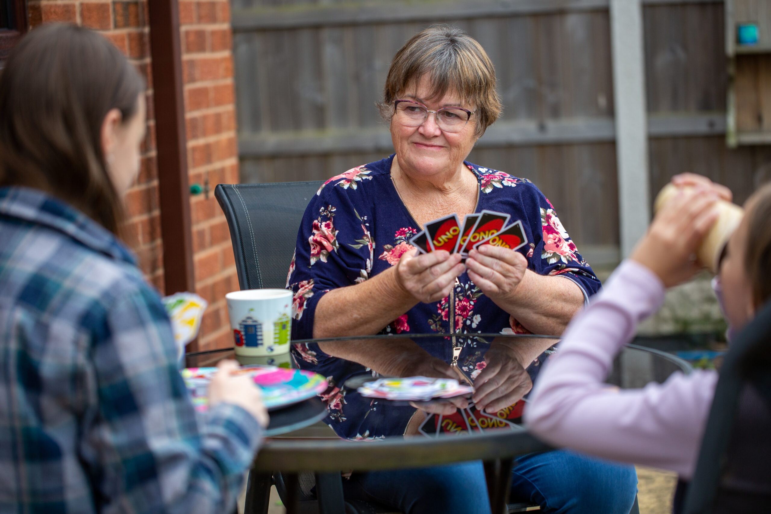 Lady in garden with grandchildren